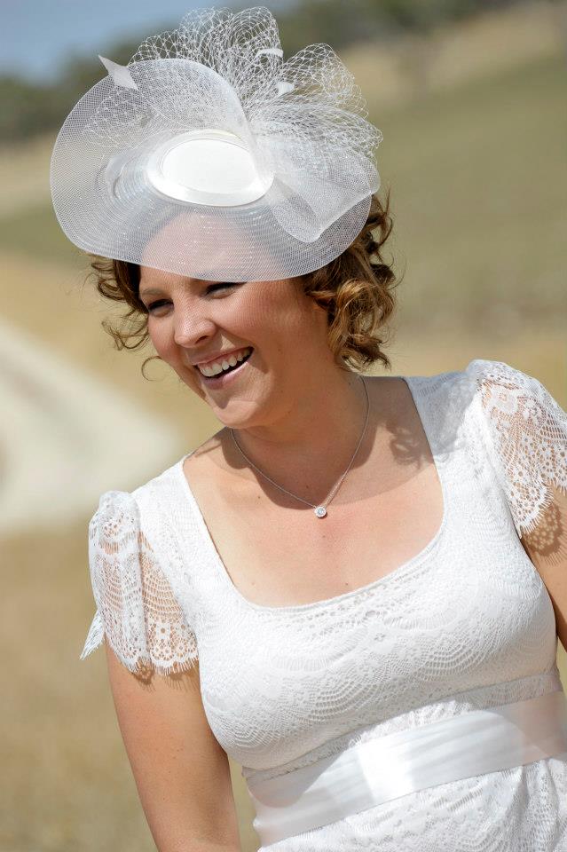 Beautiful bride looking happy in her White headpiece